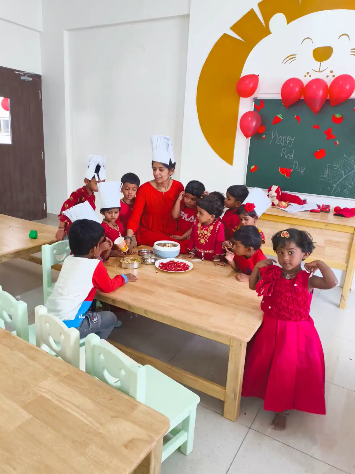 Pre-school children in red outfits at the Christmas celebration in a Takshashila School classroom