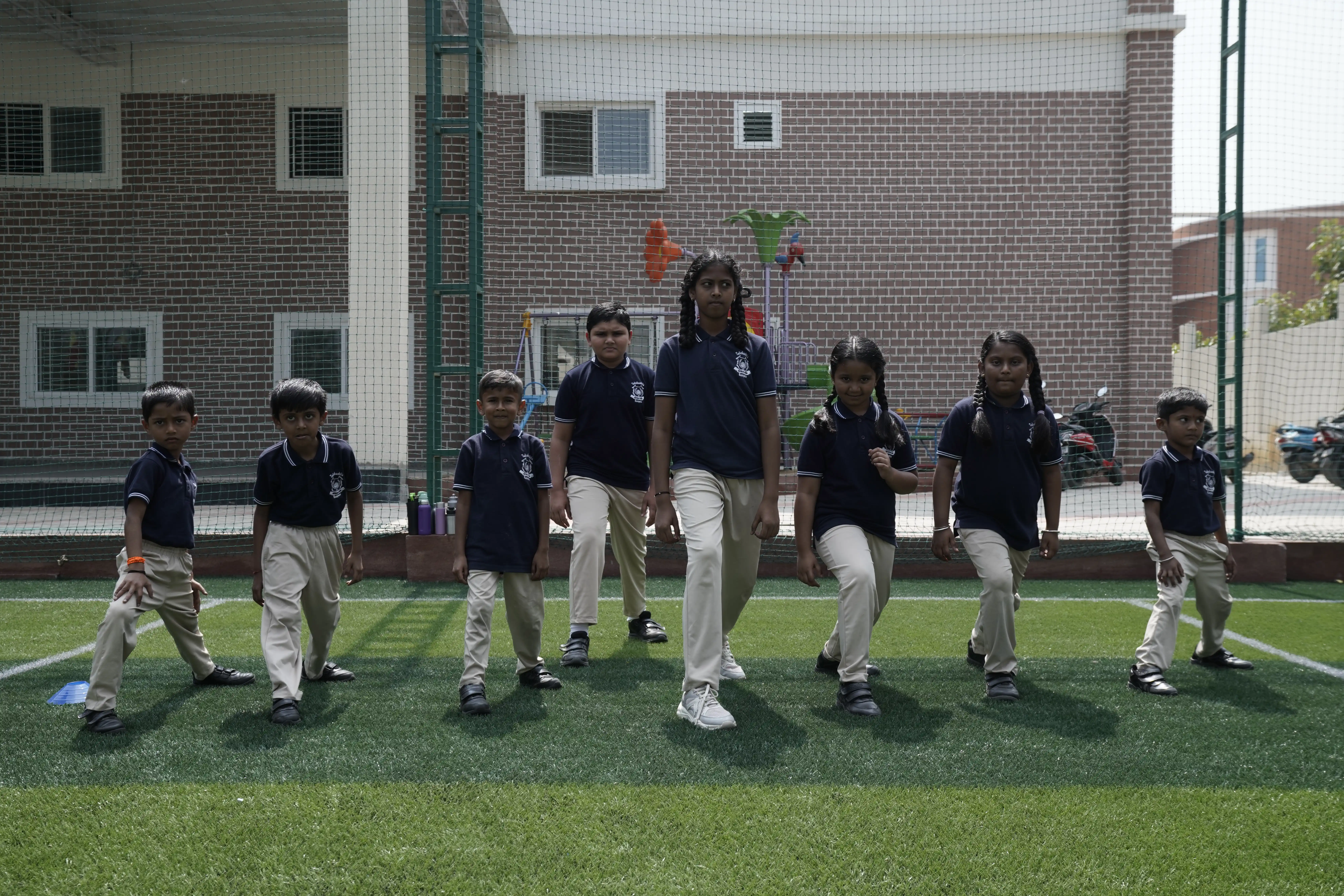 Students on the all-weather football turf in front of the Takshashila School @ Rampura building