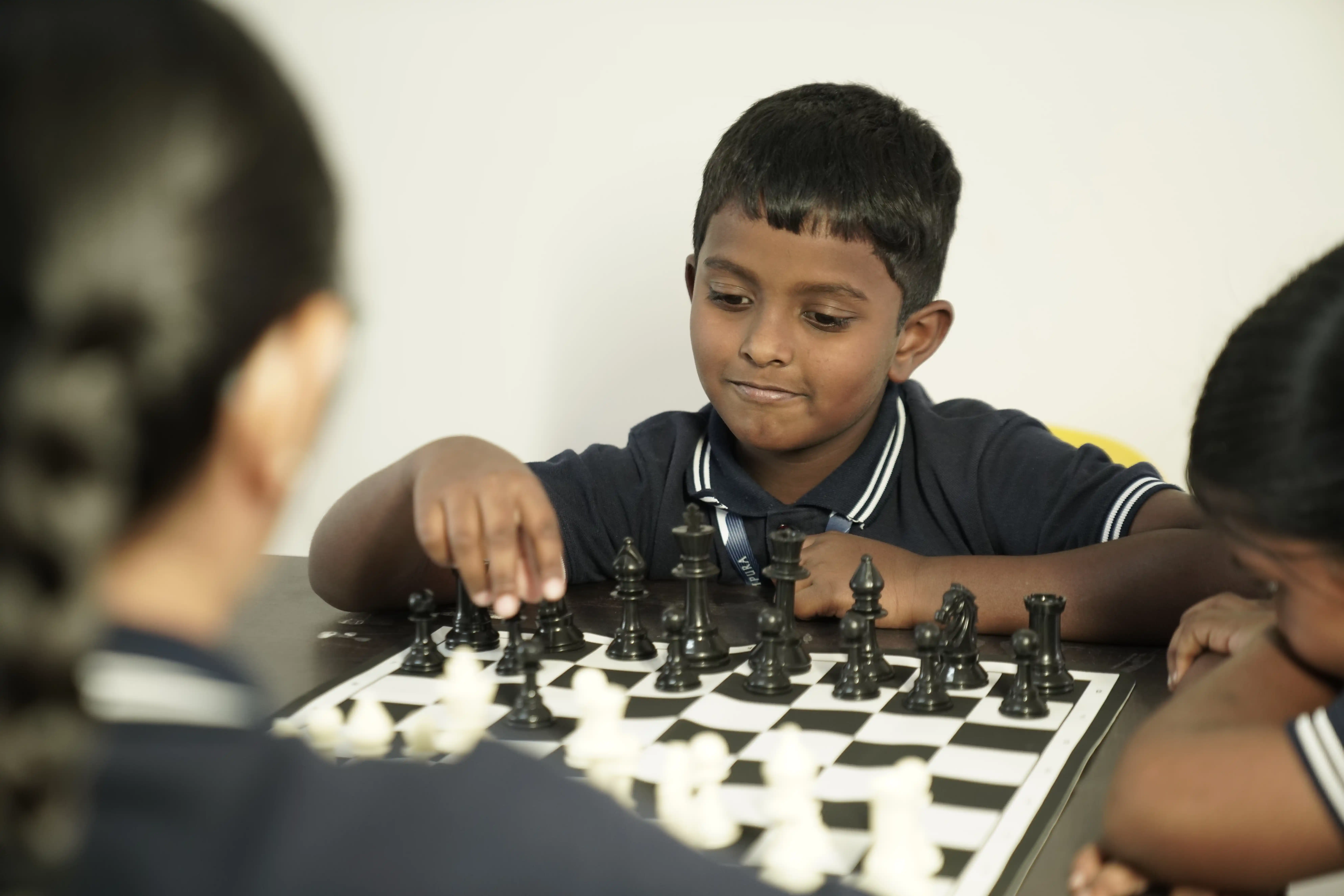 Primary student playing chess at Takshashila School @ Rampura