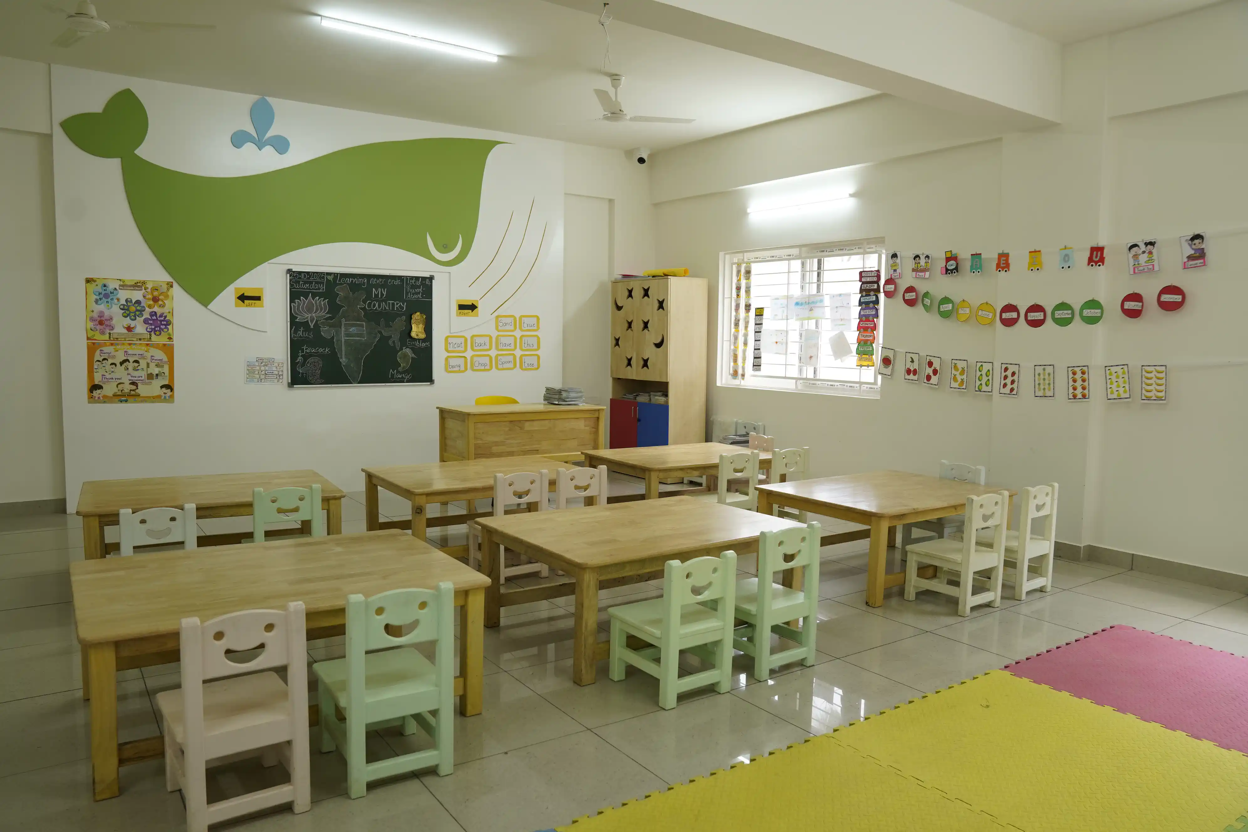 Pre-school classroom with child-sized tables and colourful learning displays at Takshashila School