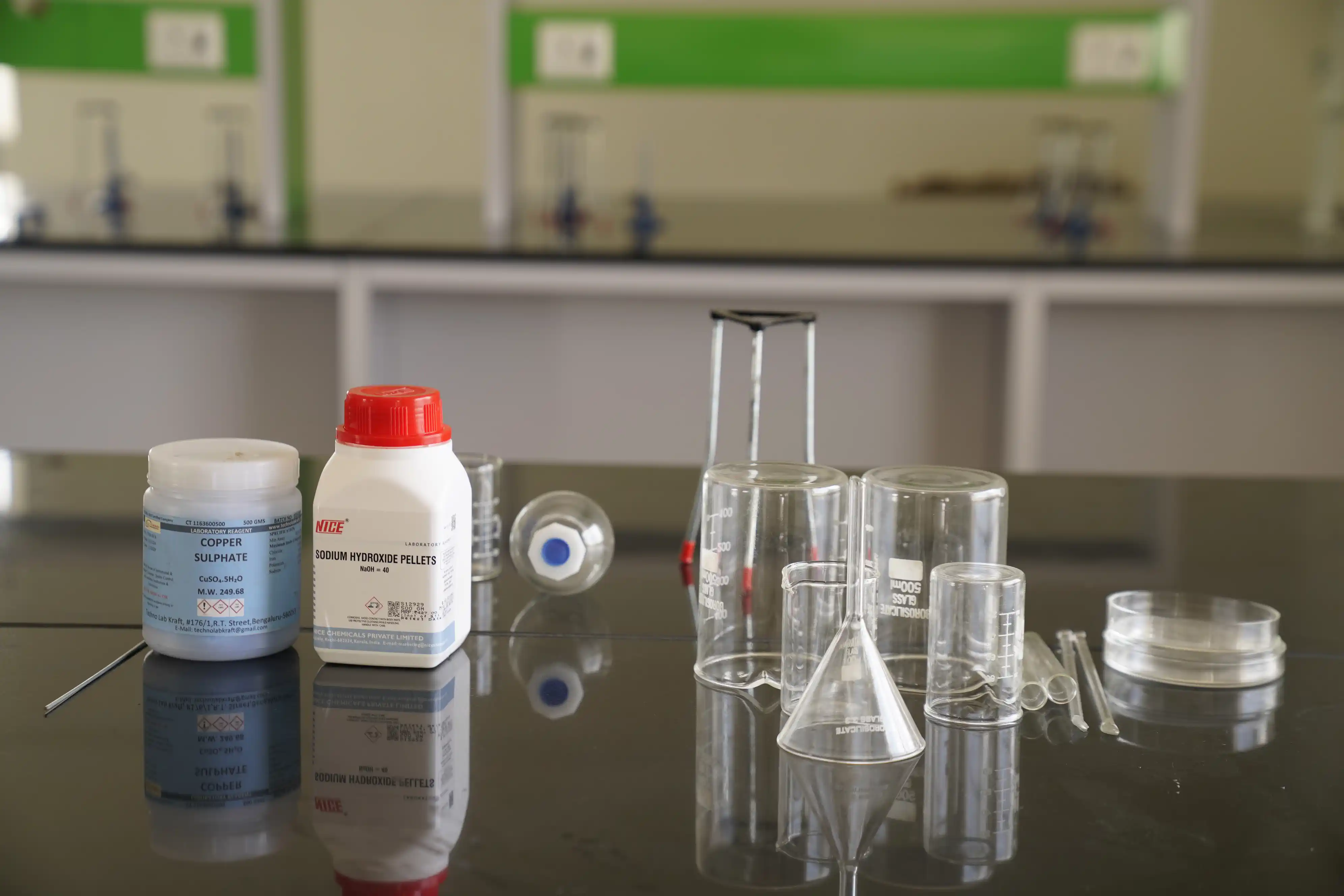 Science lab glassware and chemicals set out for experiments at Takshashila School