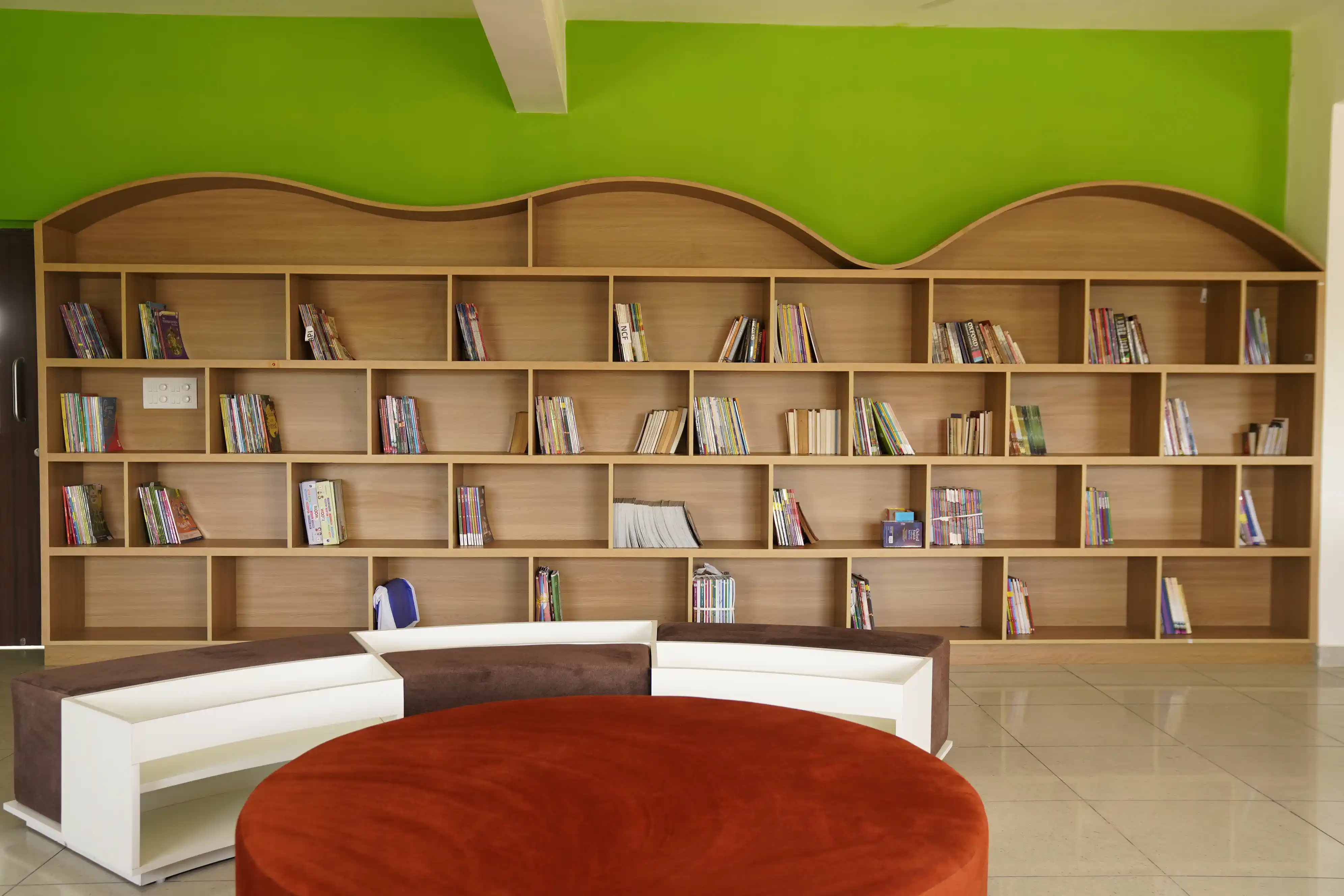 Library with bookshelves and a reading area at Takshashila School @ Rampura