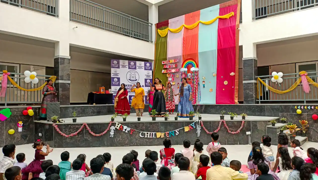Students watching a Children's Day performance at the school amphitheatre, Takshashila School