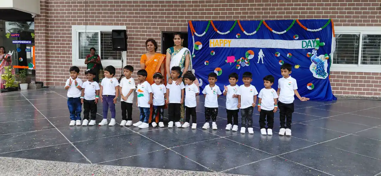 Pre-school children performing on stage at a school event, Takshashila School