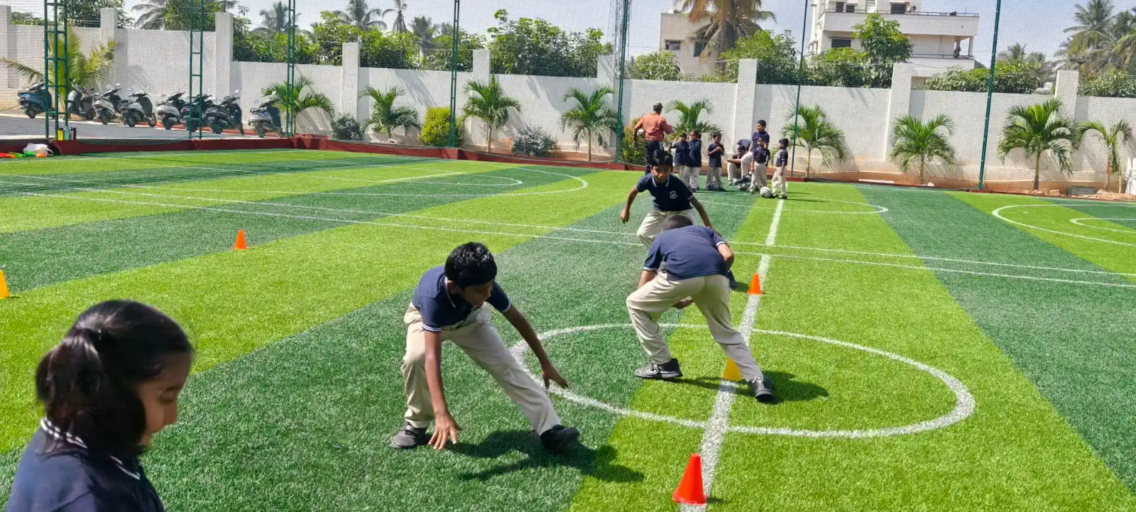 Students playing on the all-weather football turf at Takshashila School @ Rampura