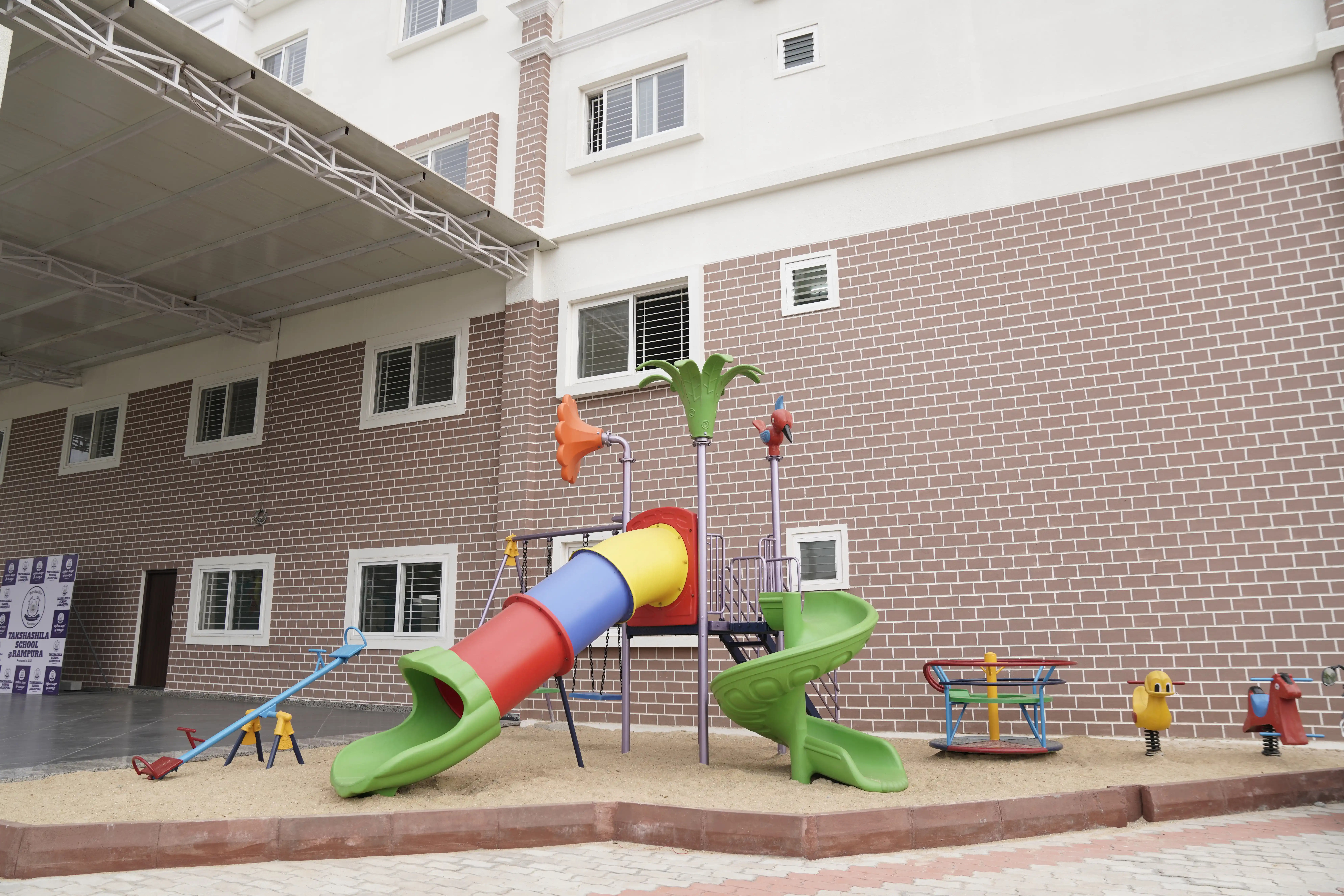 Children's play area with slides outside the Takshashila School @ Rampura building